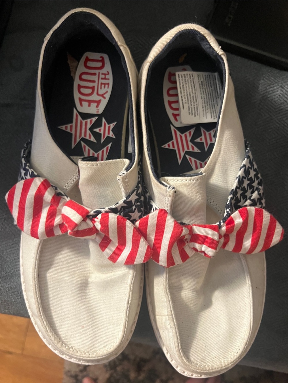 Hey Dude White Canvas Slip-Ons with Red Striped Bows and Blue Star Trim
